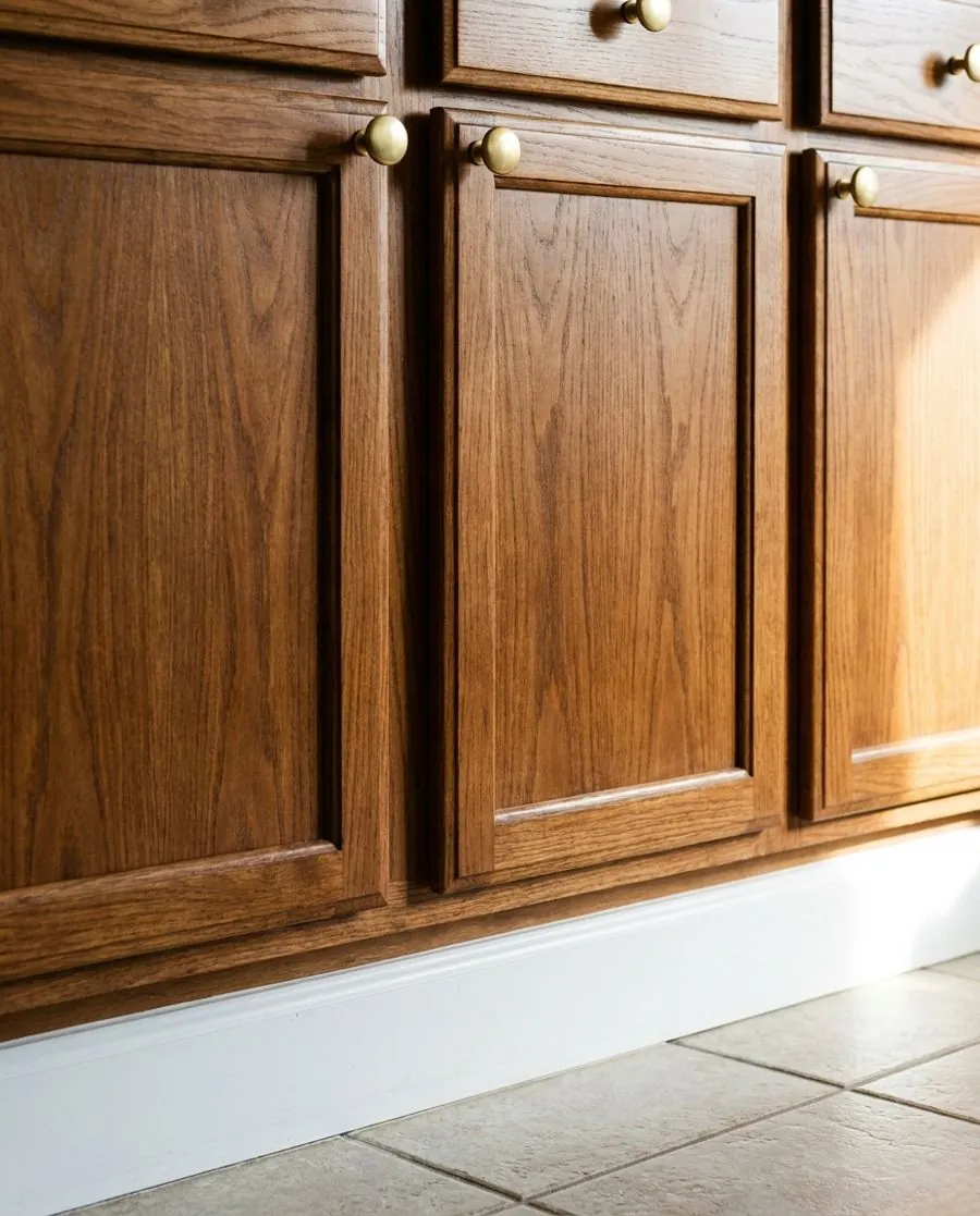 White baseboard and clean cabinet door after house cleaning in Carrollton